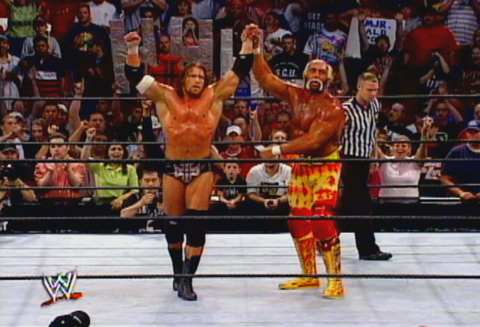 Hogan Holds Up Triple H's Arm